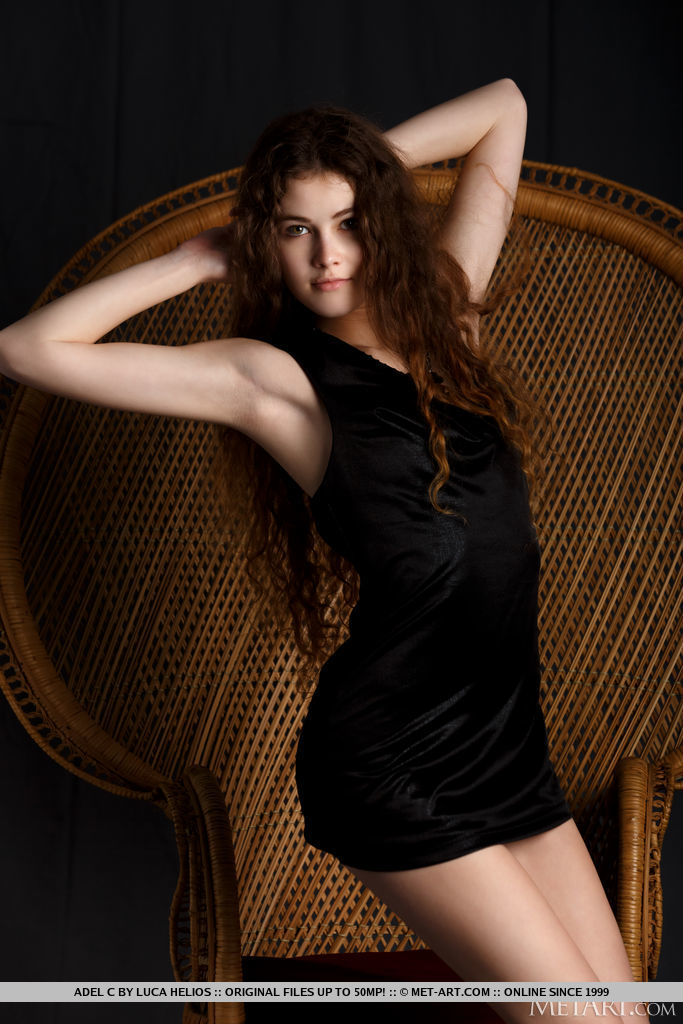 Adel C in long curly hair and a black dress